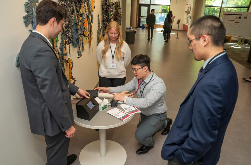 A WSU student team demonstrates a training simulator for medical students to learn about arterial pressure.