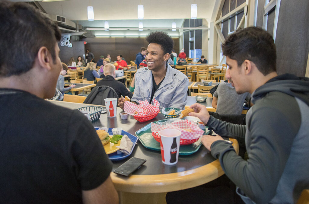 Three students eating at a table in the Southside Café.