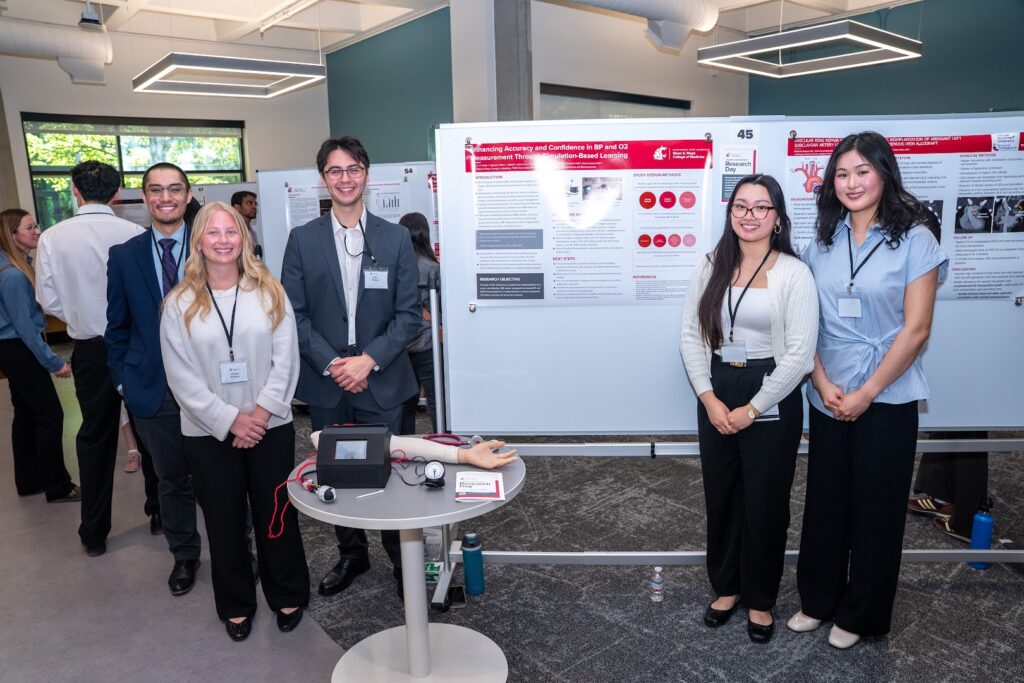 A group of students stands by a research poster during Student and Resident Research Day at the Elson S. Floyd College of Medicine.