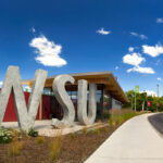 Exterior view of the Brelsford WSU Visitor Center on a sunny day.