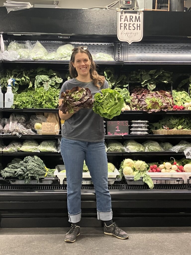 Sallie Constant holds fresh produce in her arms at the Port Angeles Food Bank. 