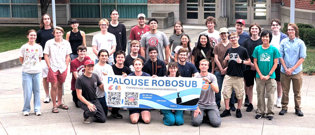 Members of WSU's Palouse Robosub club pose for a group photo while holding a club banner.
