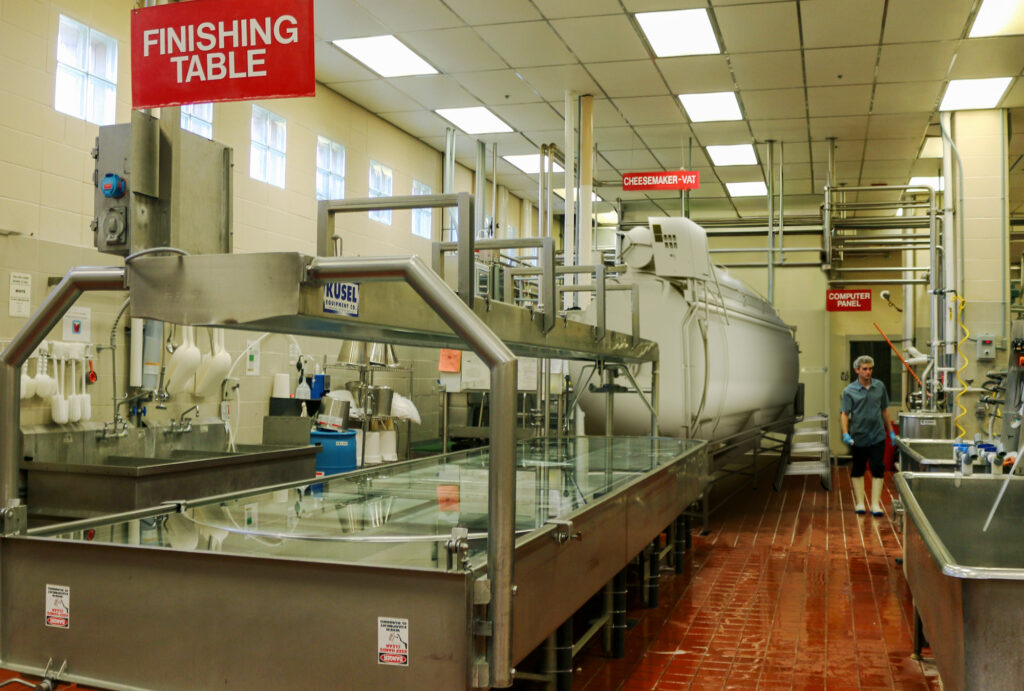 A rendering of an upgraded cheese maker and finishing table.