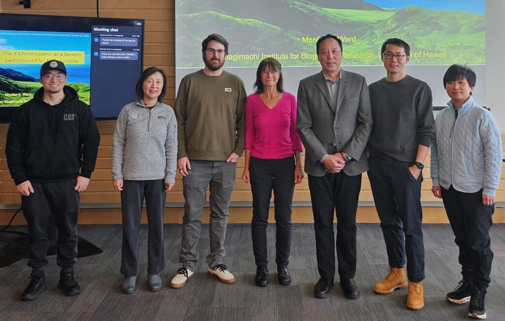 A group of scientists pose in their lab.