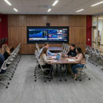 An AI-generated image of the Bloomberg lab showing students sitting at computer terminals.