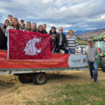 Students on a wagon ride touring a farm and winery.