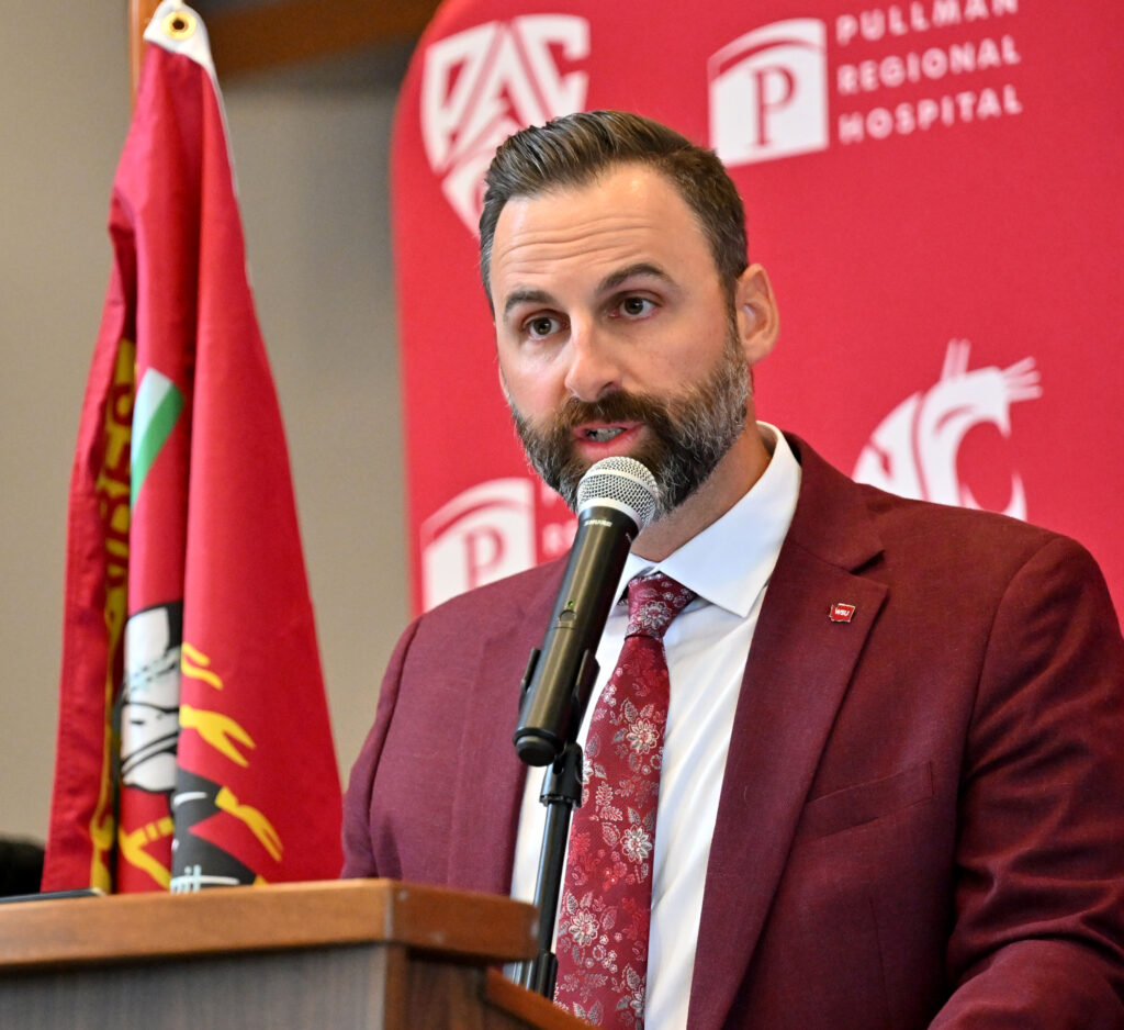 Closeup of Jon Haarlow addressing a crowd from a podium.