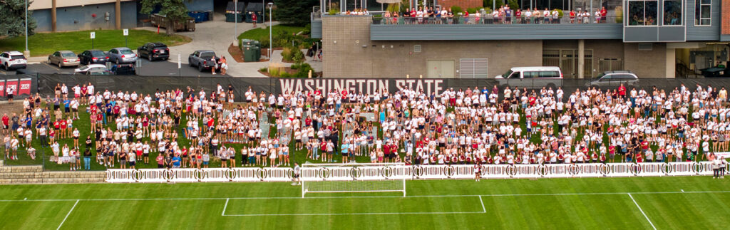 An aerial view of fans alongside a WSU soccer field.