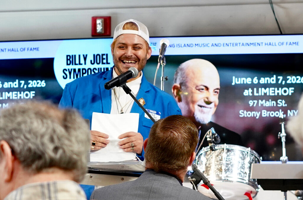 WSU student Blake Love speaking to an audience at the Billy Joel Symposium.