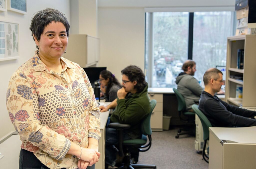 Professor stands among students in her laboratory.