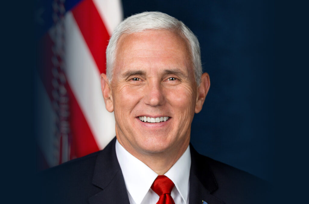 Closeup of Mike Pence with an American flag in the background.