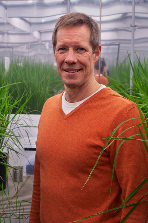 Closeup of Mark Lange in a greenhouse.