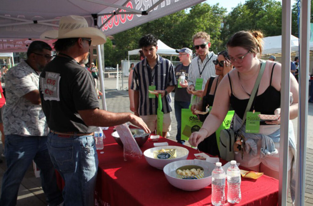 WSU employees hand out samples of Cougar Gold cheese to visitors at the Crave! Northwest food festival.