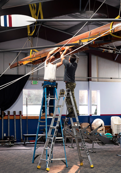 Workers prepare a boat for shipping to WSU.
