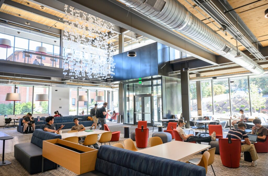 Students studying and visiting in the main lobby of Schweitzer Engineering Hall.