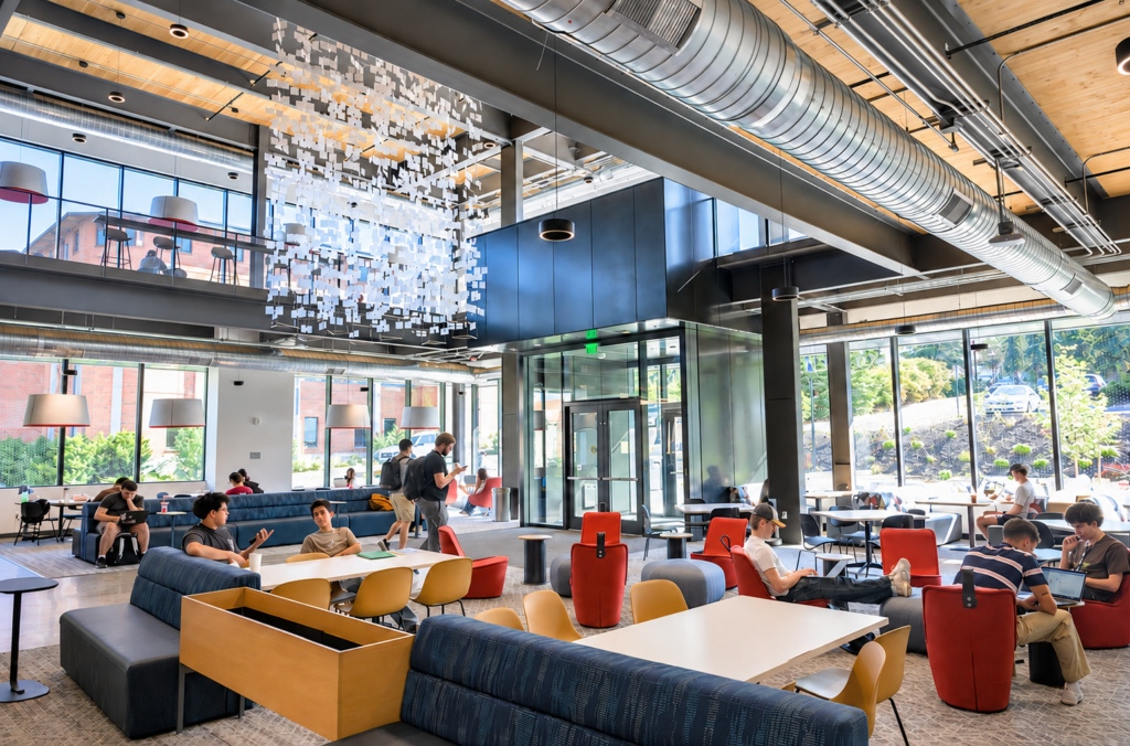 Students studying and visiting in the main lobby of Schweitzer Engineering Hall.