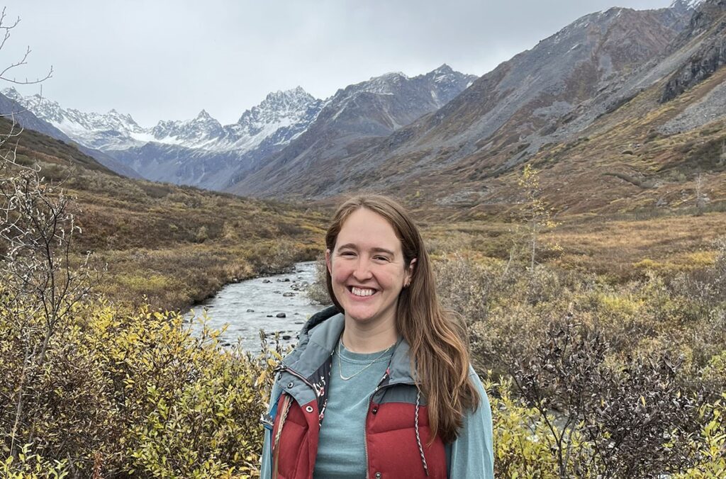 Researcher poses in the Alaskan wilderness.