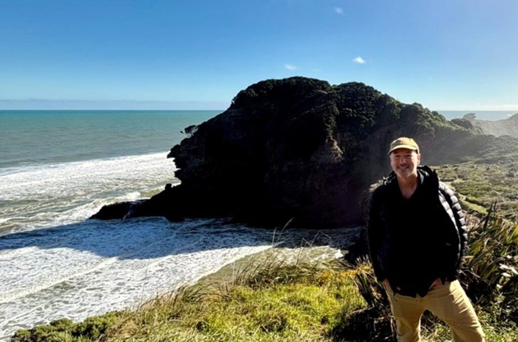 Professor poses along the coast