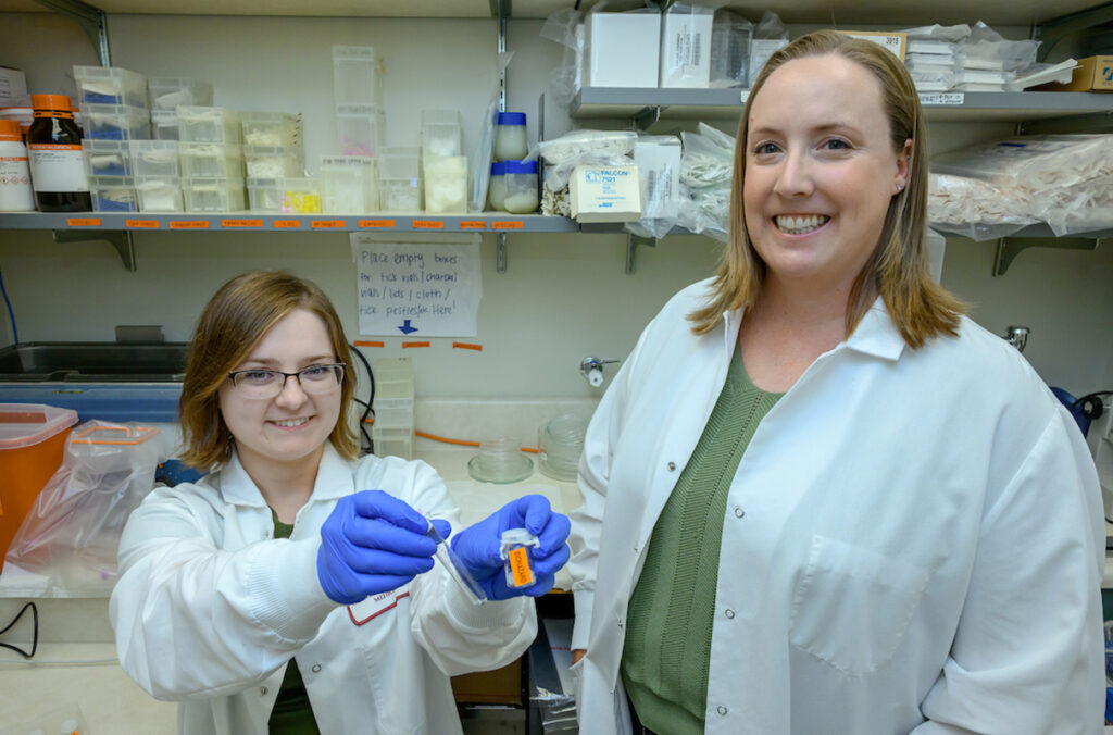 Two women pose for a picture in a laboratory at WSU.