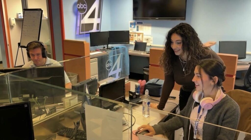 An intern can be seen working in the KXLY newsroom.