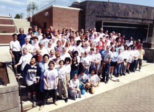 A group photo of the moving team outside the entrance of Terrell Library.