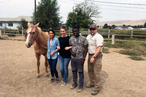 Students practice precise communication in haltering horses at senior instructor Jayne Beebe’s Spirit of Hope equine center.