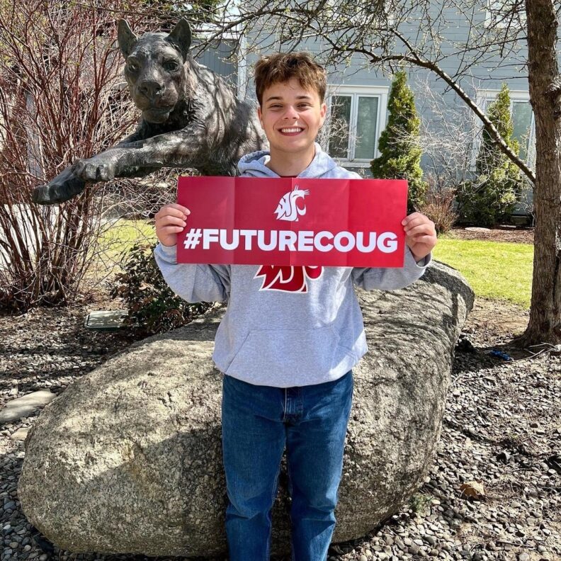 Young student holding #FutureCoug poster.