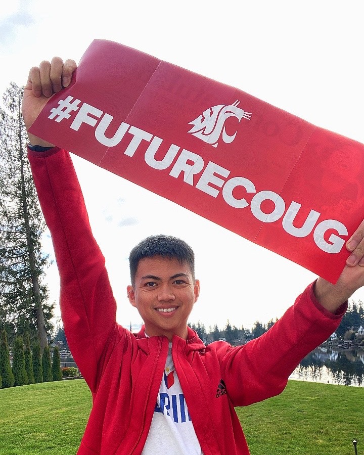 Young student holding #FutureCoug poster.
