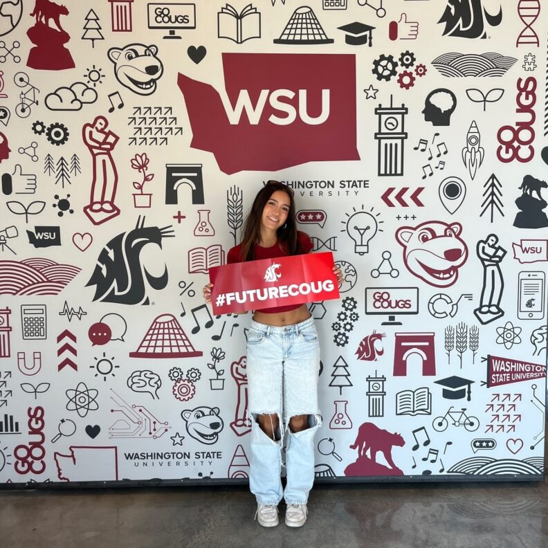 Young student holding #FutureCoug poster.