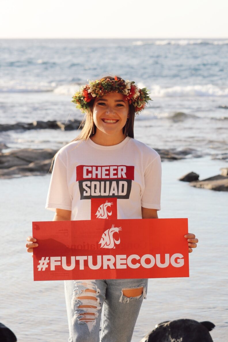 Young student holding #FutureCoug poster.