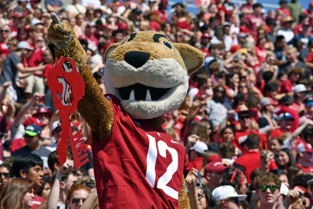 Butch T. Cougar holds up a large set of keys during a Cougar Football Game at Gesa Field.