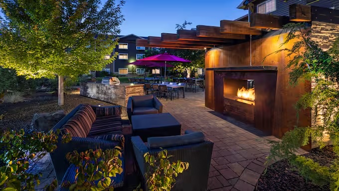 Outdoor seating with a lit fireplace.