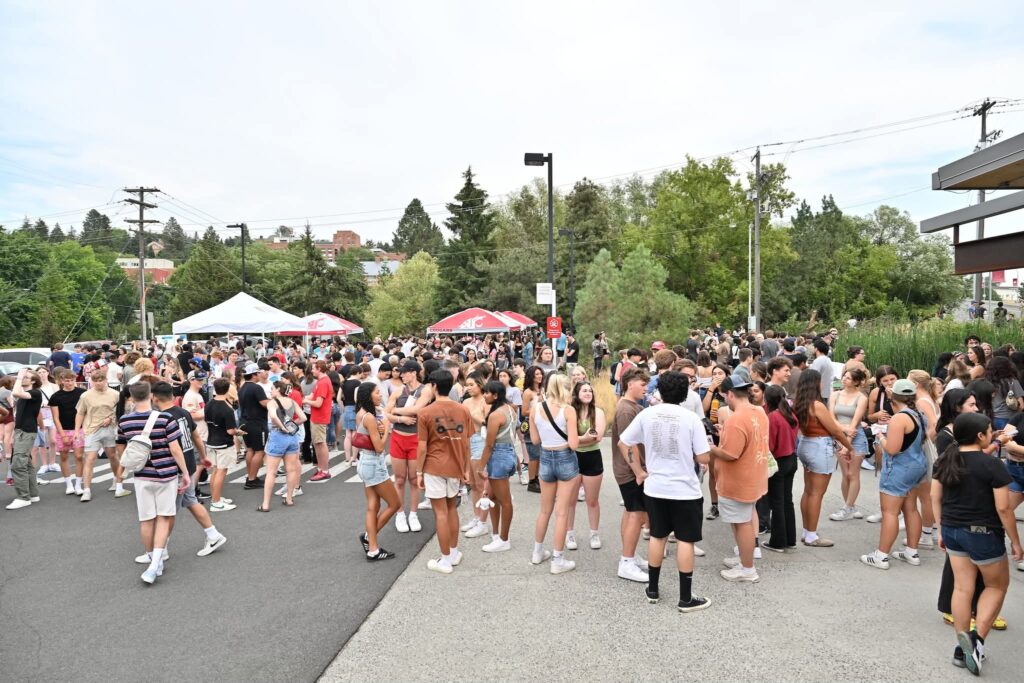 A crowd of students gathered at a street fair.