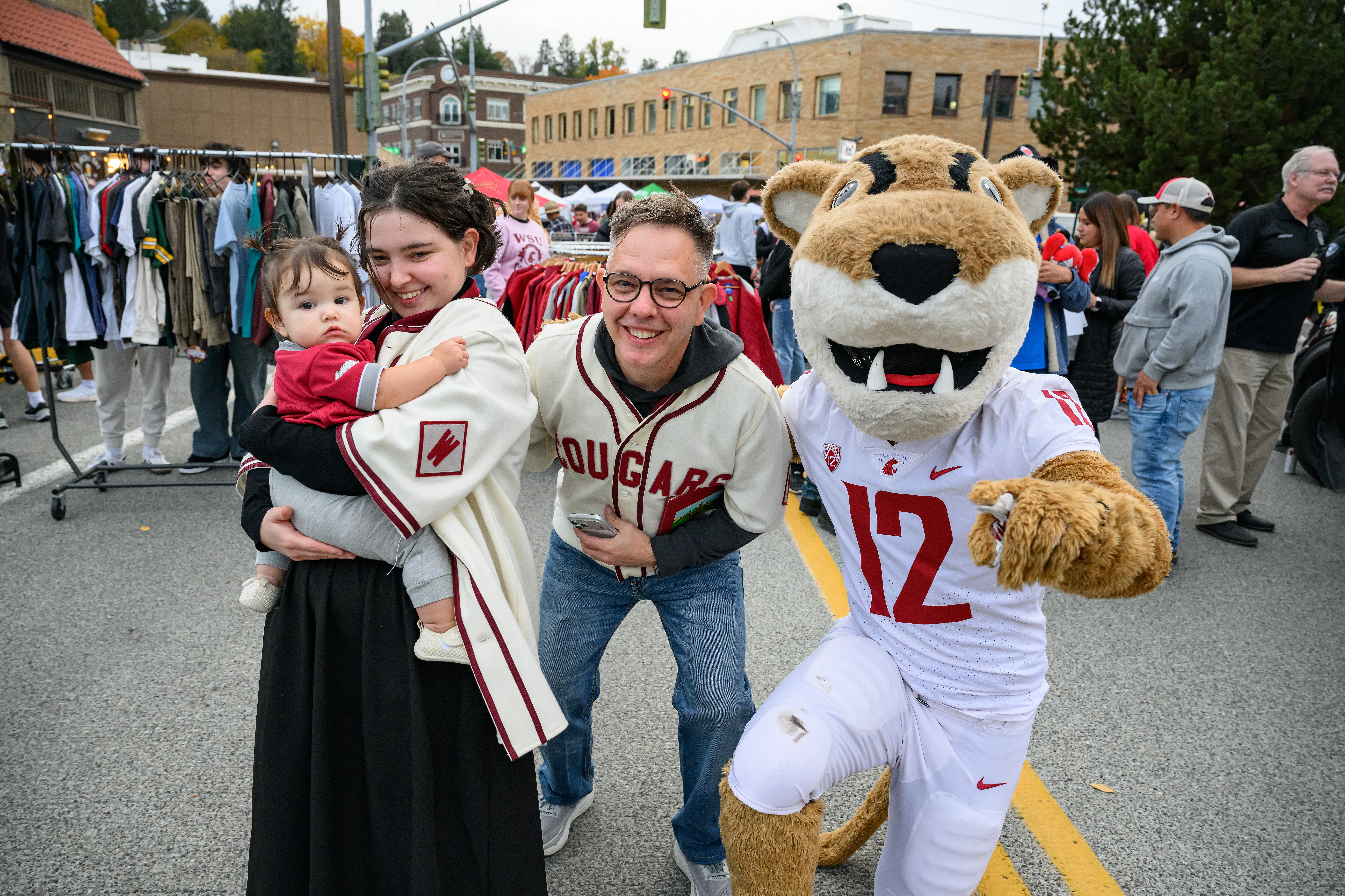 WSU mascot Butch cougar posing with a smiling family.