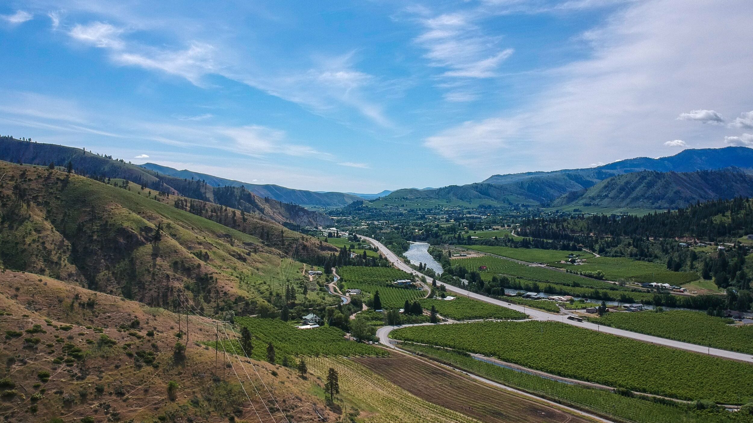 Aerial view of hills, orchards, and river
