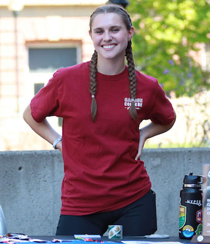 A person with two braids wearing a red 