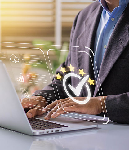A person in a suit typing on a laptop in an office setting, with overlaid digital icons including a cloud, bar chart, and a checkmark surrounded by stars.