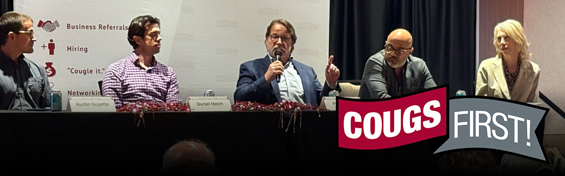 Panel discussion at a CougsFirst! event with five seated speakers and a banner displaying the CougsFirst! logo.