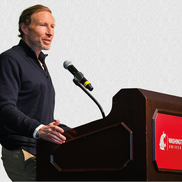 Jeff Kearl giving the keynote address at a podium during the 2025 Business Plan Competition.