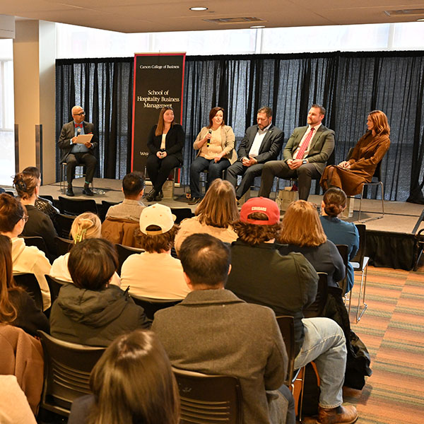 Panelists speak on stage during the “Building Your Future: Career Insights from Hospitality Industry Leaders” session at the Hospitality Week Industry Expert Panel, with an audience seated in front.