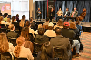 Panelists speak on stage during the “Building Your Future: Career Insights from Hospitality Industry Leaders” session at the Hospitality Week Industry Expert Panel, with an audience seated in front.