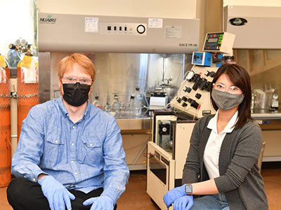 Members of WSU’s Ananta team sitting in a lab with bioreactor equipment and gas tanks, wearing gloves, reflecting their work on T‑cell expansion technology.