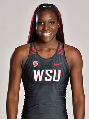 Charisma Taylor wearing a WSU athletic uniform with long dark red hair and a black headband.