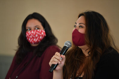 Hazelmae Overturf speaks into a microphone beside fellow panelist Karli Barich during the 2021 Executive MBA Leadership Conference.