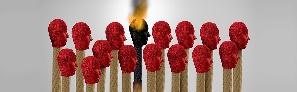 A row of red matchsticks shaped like heads surrounds a single burned, flaming match at the center.