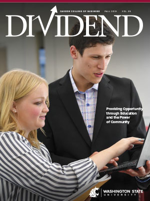 Dividend 2021 magazine cover showing two people collaborating at a laptop, with the headline “Providing Opportunity through Education and the Power of Community” and WSU branding.