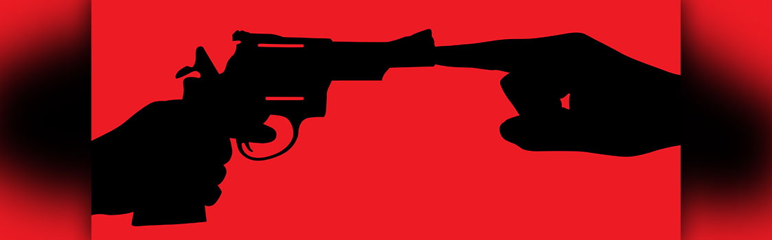 Silhouetted hand holding a revolver faces another hand whose extended finger presses against the gun’s barrel, set against a bright red background.