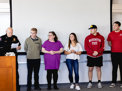 Award recipients stand in a row during the WSU Safety and Wellness Expo ceremony recognizing their life‑saving efforts.