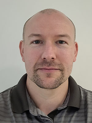 Headshot of Ash Hyman.