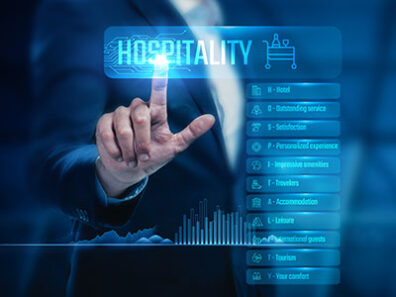 A business professional touches a glowing digital interface labeled “Hospitality,” surrounded by icons and menu options related to hotel and guest services.